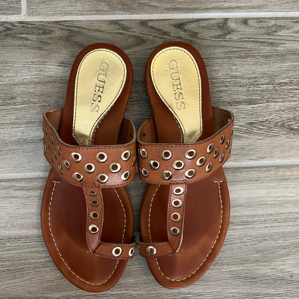 Guess brown leather sandals with gold grommet details. Size 6